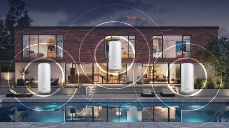 Three Netgear Orbi 870 units standing together, representing a whole-home coverage kit.