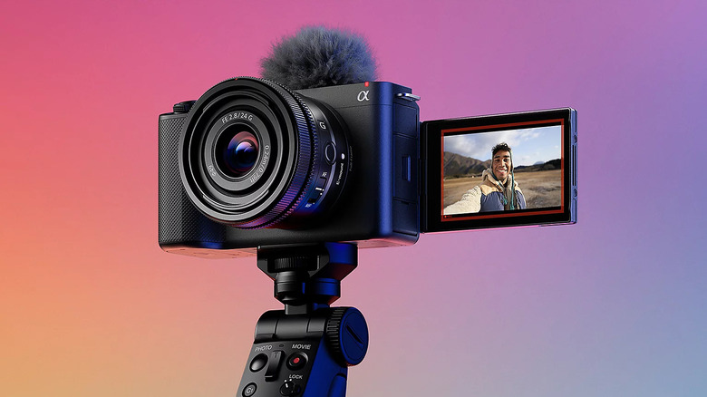 A Sony ZV-E1 full-frame camera mounted on a tripod with the screen facing the subject.