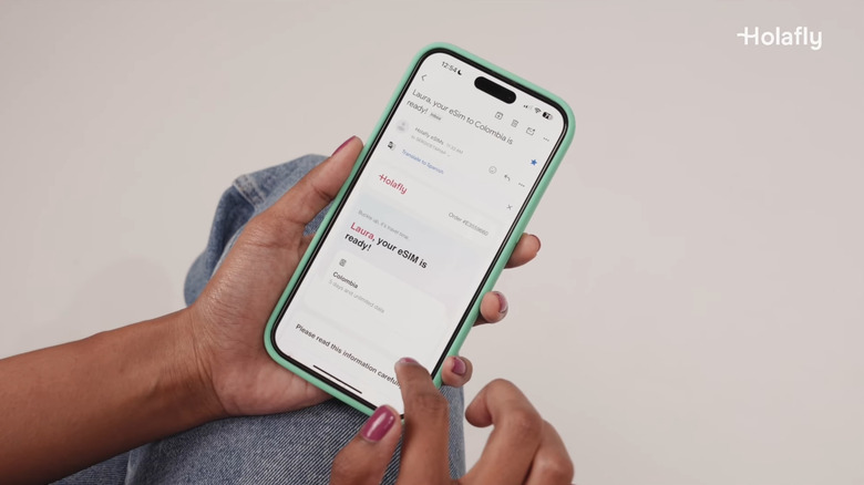 Close-up of a person configuring a Holafly eSIM on their smartphone.