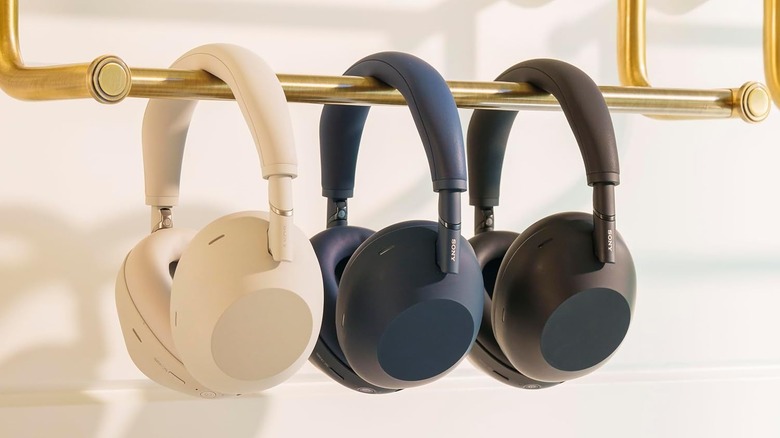 Multiple Sony WH-1000XM6 headphones in different colors hanging on a rack.