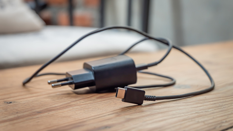 A close-up of a USB-C wall charger with a black finish.