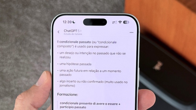 The ChatGPT app interface displayed on an iPhone held in a hand.