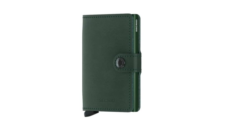 A slim metallic wallet with the Secrid brand name visible on the edge.