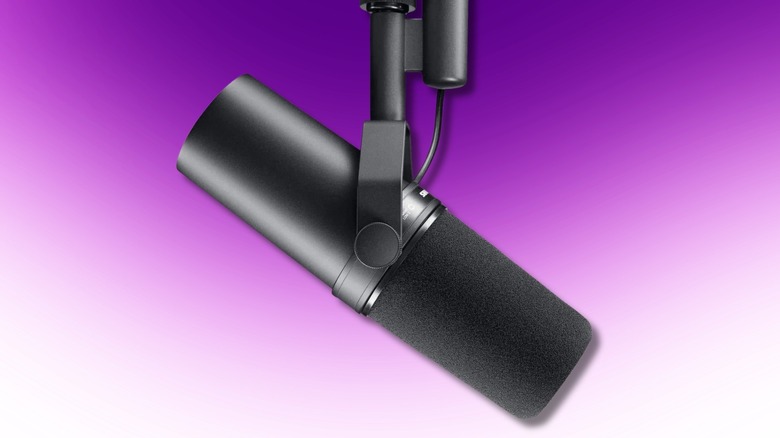 Shure SM7B dynamic vocal microphone with foam windscreen on a purple background.