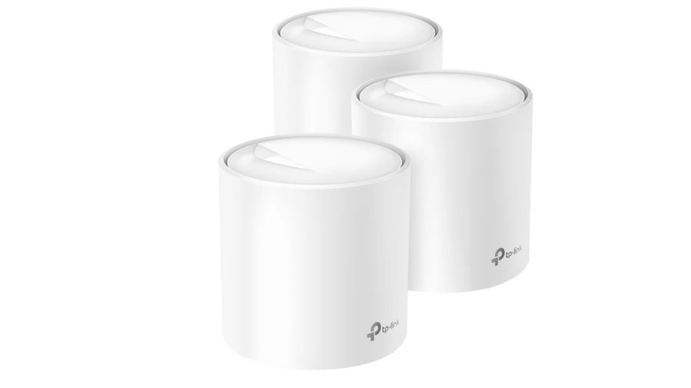 A three-pack of white TP-Link mesh Wi-Fi devices positioned side-by-side.