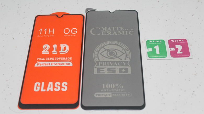A comparison between a clear tempered glass protector and a matte finish screen protector.