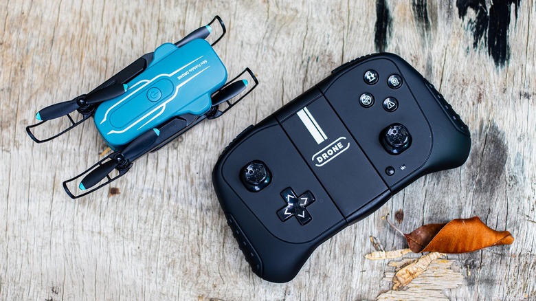 The Oviliee S17 drone folded into a compact shape next to its dedicated remote control.