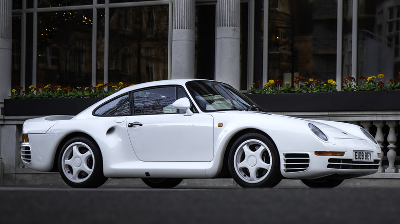 A silver Porsche 959 supercar parked outdoors.