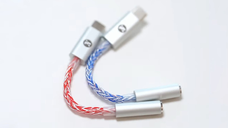 Jcally JM6 Pro USB-C DAC dongles in blue and red on a clean white background.