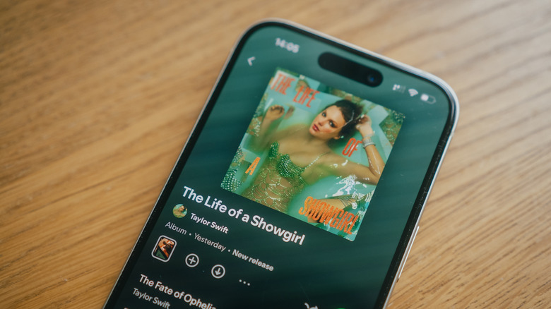 Close-up of a smartphone screen showing a popular artist's album on a music streaming service.