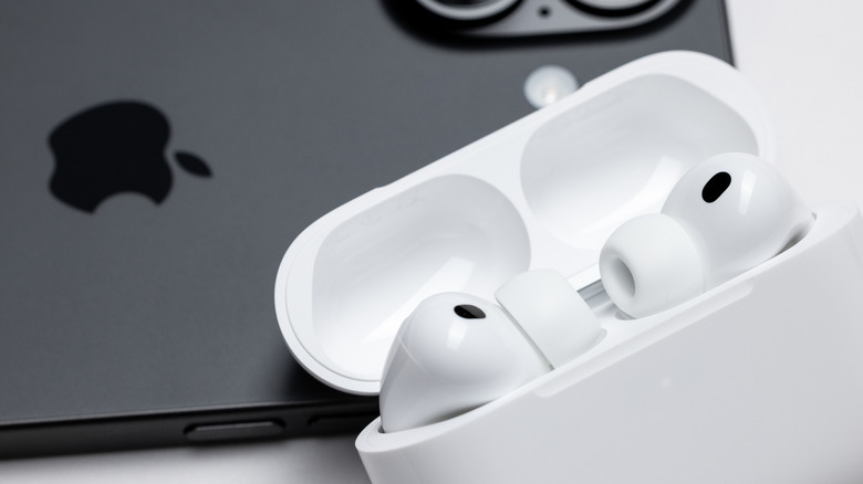 Close-up of white stem-style wireless earbuds on a clean background.
