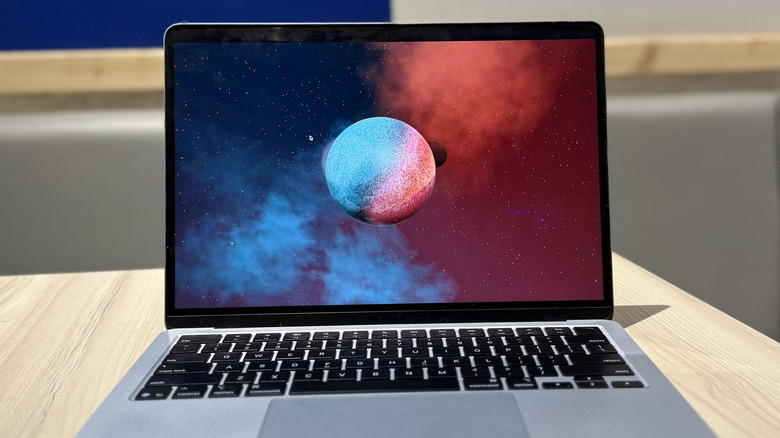 Top-down view of a MacBook Air on a table, representing the testing rig.