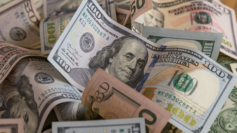 A close up view of several fifty and one hundred dollar bills.