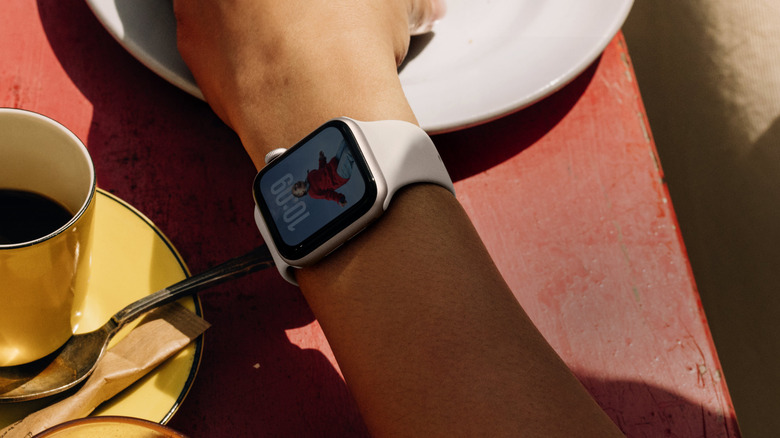 A close-up of a smartwatch being worn on a wrist.