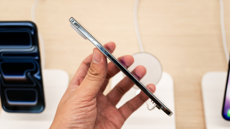 A person holding the iPhone Air sideways to emphasize its 5.6mm ultra-thin frame compared to traditional smartphones.