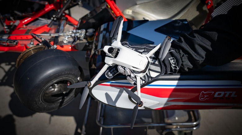 A person wearing gloves holding the compact Antigravity A1 drone in their hand.