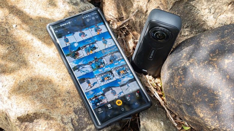 A smartphone running the Insta360 app next to the Insta360 X5 camera.