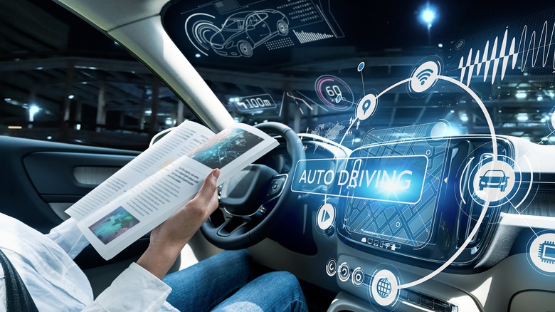 Interior view of a semi-autonomous vehicle cockpit showing advanced digital displays and a steering wheel.