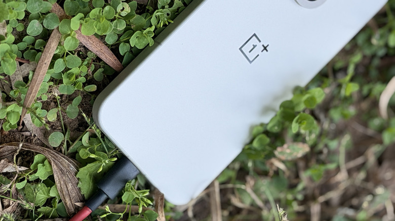 OnePlus 15 connected to a SuperVOOC fast charger.