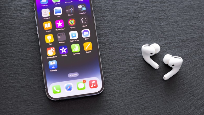 AirPods resting next to an iPhone to represent the native Apple ecosystem.