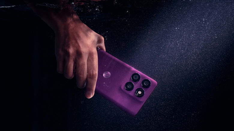 A Motorola Edge 60 Pro being held completely submerged underwater.