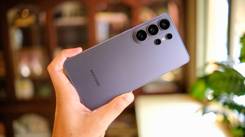 A hand holding the large display of the Samsung Galaxy S26 Ultra.
