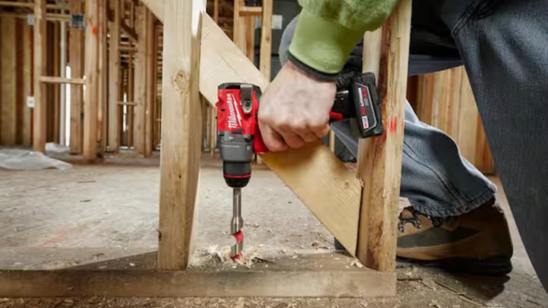 Close-up of the Milwaukee M12 Fuel Hammer Drill being used for drilling.
