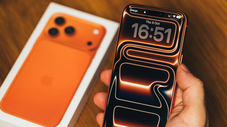 A person's hand holding an iPhone 17 Pro Max, showing its large display and modern design.