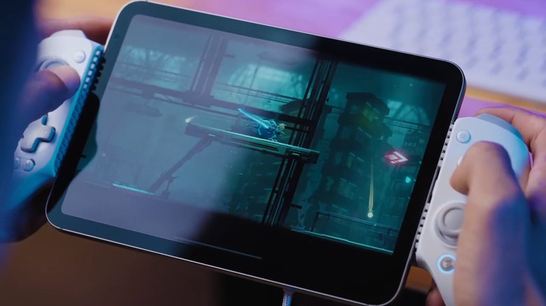 A GameSir G8+ controller attached to an iPad showing a mobile game in progress.