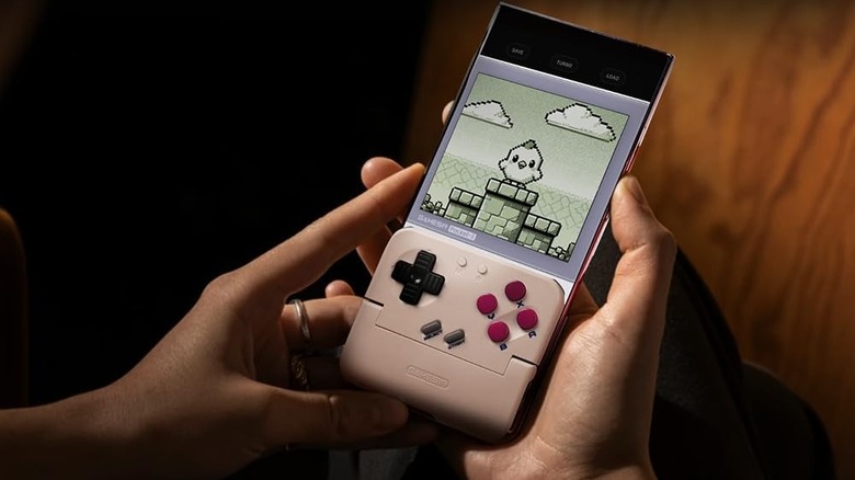 Close-up of a smartphone with a physical gaming controller attachment featuring responsive buttons and joysticks.