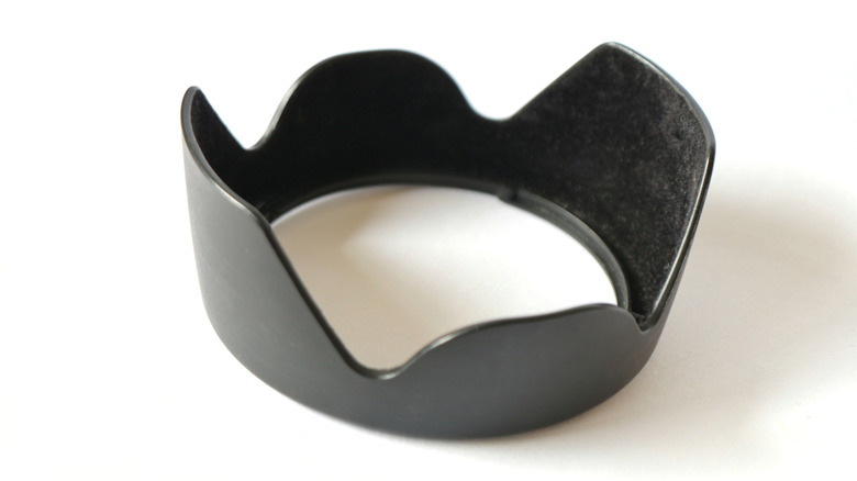 A black plastic lens hood on a plain white background.
