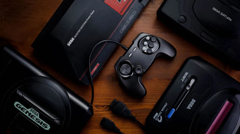 A black Retro Fighters BrawlerGen controller connected to a Sega Genesis console.