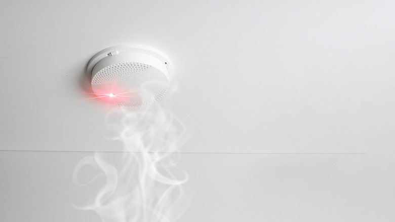 A modern smoke alarm activated by rising smoke.