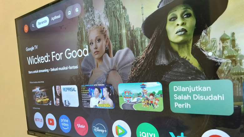 A wide shot of a smart TV with the default Google TV operating system in a home living room.