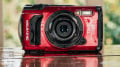 A rugged red OM System TG-7 camera designed for extreme environments.