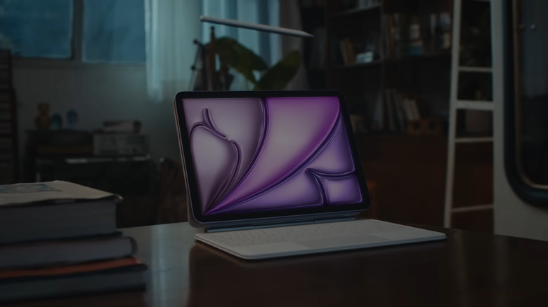 An iPad propped up on a desk with an Apple Pencil and a keyboard nearby.