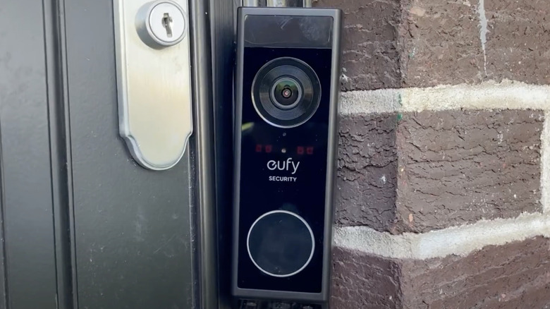 A modern smart lock installed on a door frame.