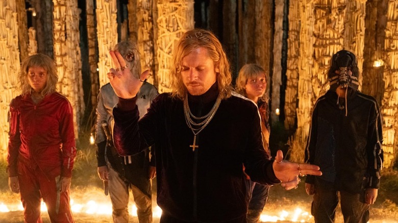 The main characters standing together in the skeletal surroundings of the bone temple.