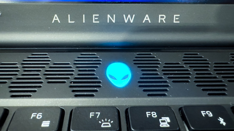 Close-up of the iconic Alienware logo and cooling vents on a gaming laptop.
