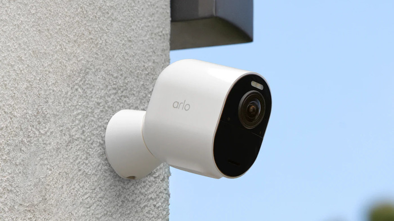 An Arlo Ultra 3rd Gen wireless camera mounted to a brick wall.