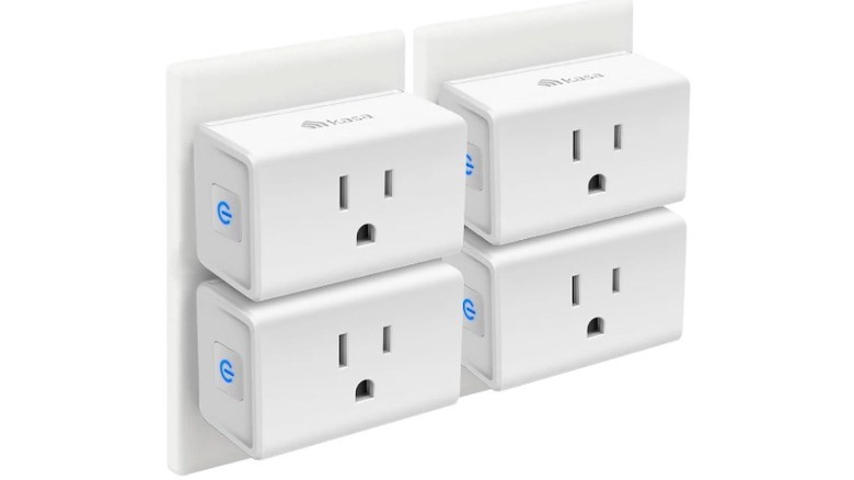 Four Kasa Smart Plug Mini units plugged into wall outlets in a row.