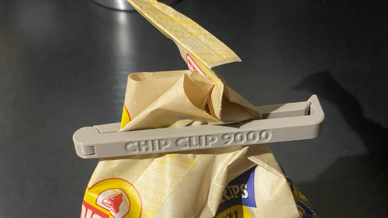 A colorful 3D printed chip clip tightly sealing a plastic snack bag.