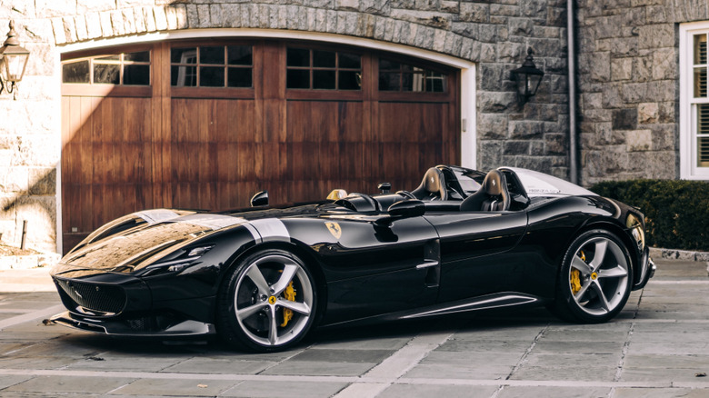 A Ferrari Monza SP2 roofless speedster finished in silver with a single yellow racing stripe.