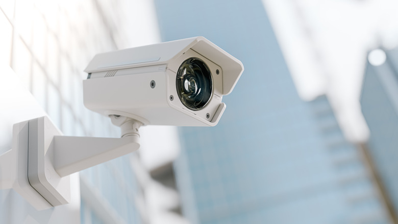 A professional security camera mounted on the corner of a building's exterior.