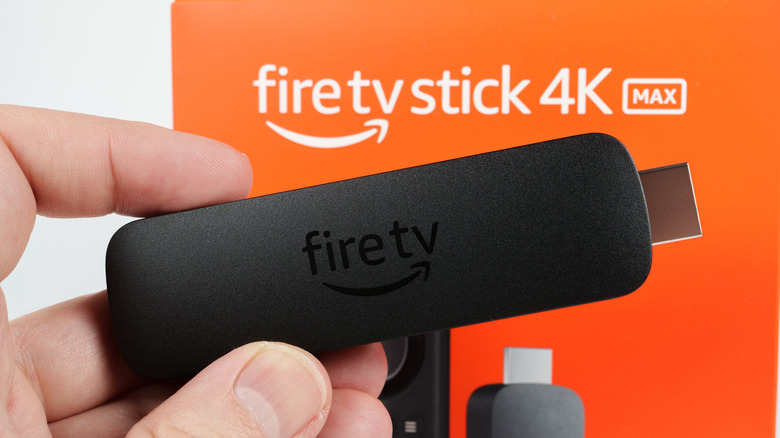 A hand holding the Amazon Fire TV Stick 4K Max 2023 model.