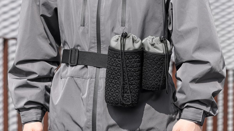 Multiple padded lens pouches attached to a belt for secure travel and organization.
