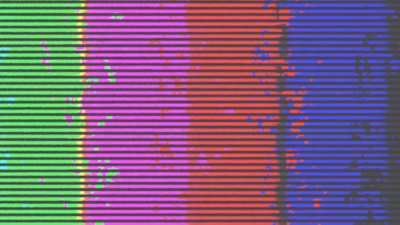 A television screen displaying distorted colors and digital artifacts caused by a poor connection.