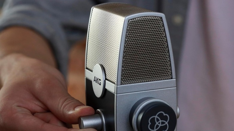 A silver AKG Pro Audio Lyra USB microphone on a vintage-style stand.