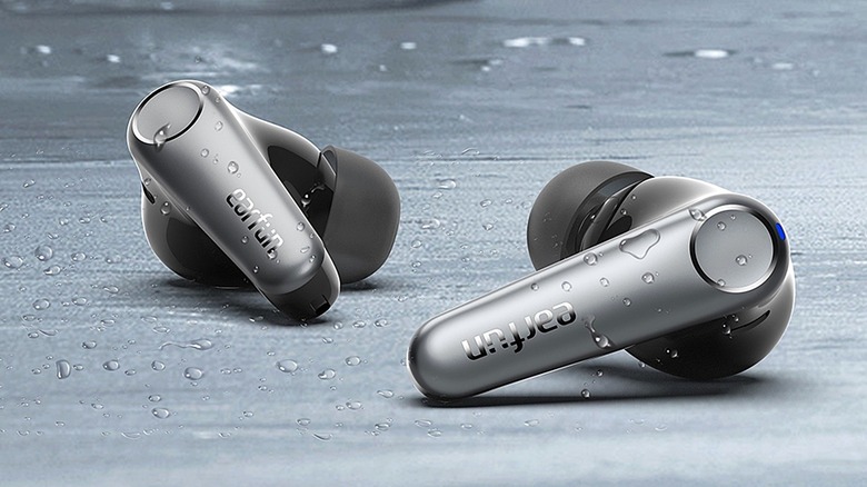 Close-up of EarFun Air Pro 3 wireless earbuds with water droplets on the exterior shell.