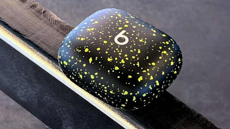 The compact Powerbeats Pro 2 Nike Edition charging case showing the Volt splatter design.